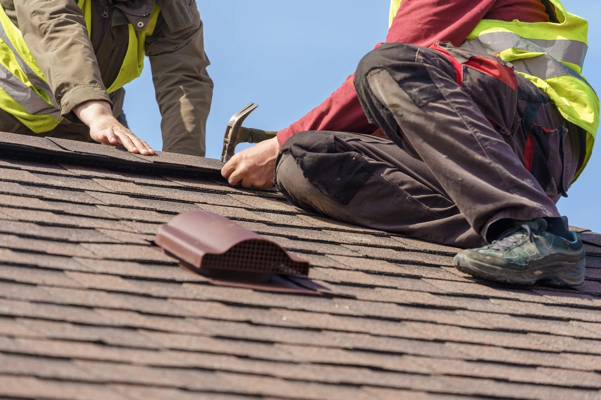 close up to workers repairing roof