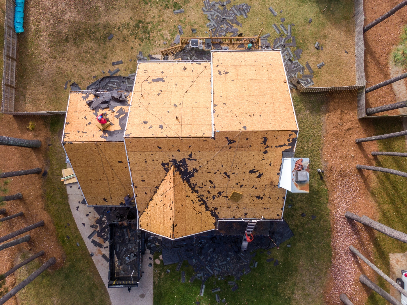 downward drone footage of roof deck and sheathing during roof replacement