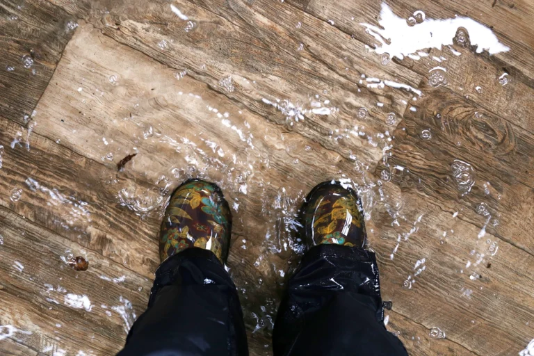 looking down at feet in standing water on hard wood floors