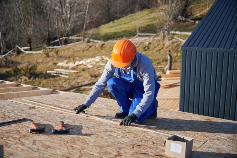 roof tech in hard hat measuring roof materials