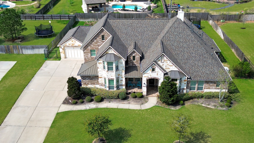 front aerial view of magnolia roofing system installation with asphalt shingles