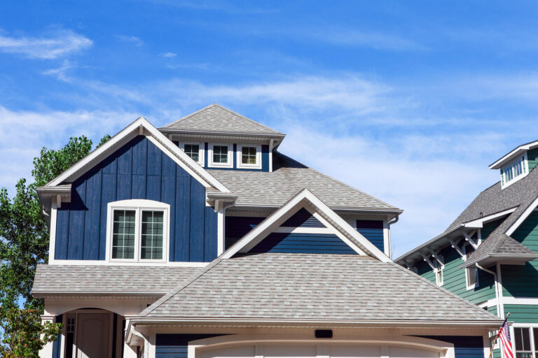 new roof-blue sided house with new gray shingled roof