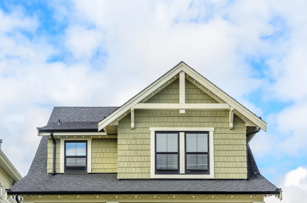 green home with shingle roof